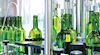 Green bottles in bottling plant