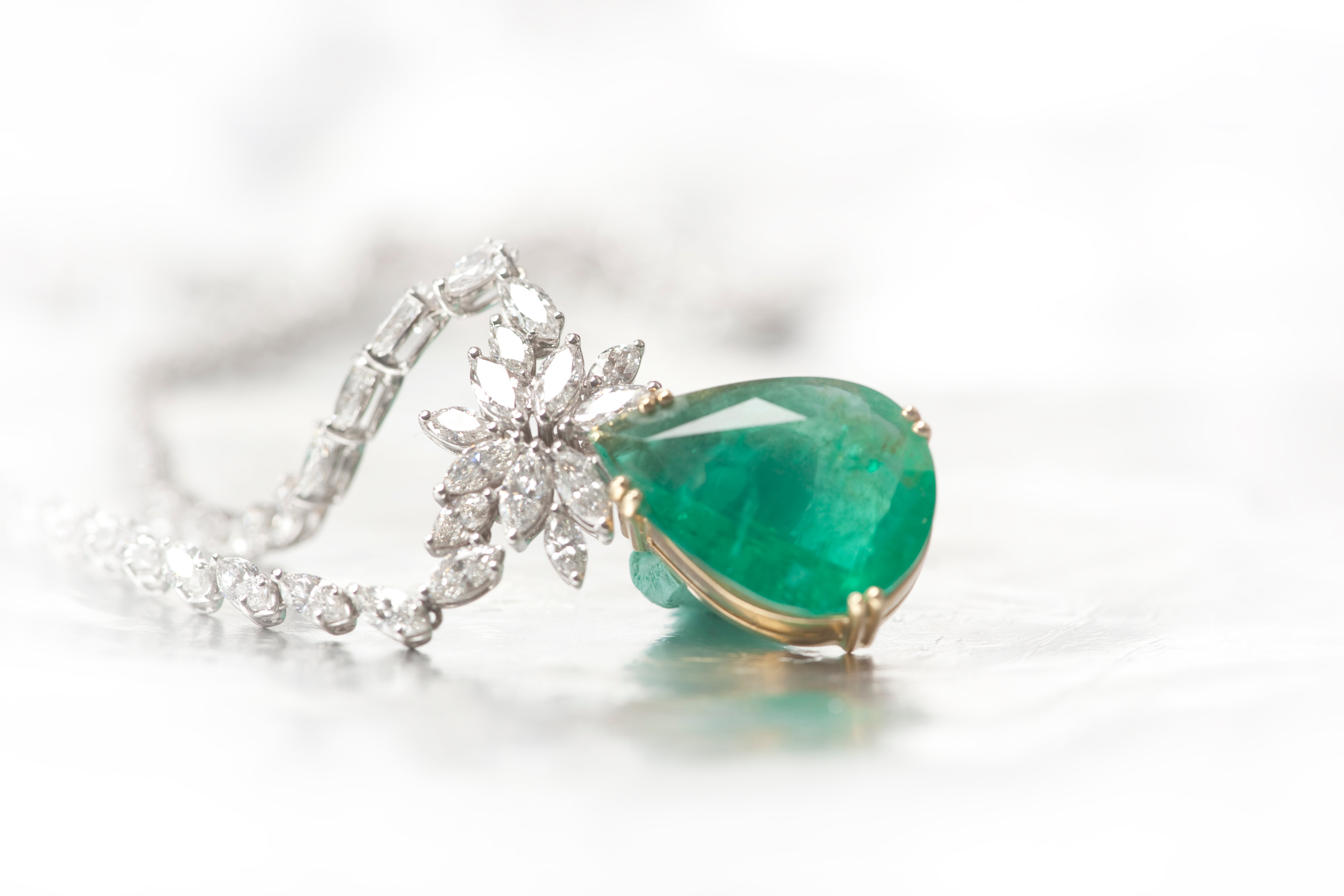 Image of a high-value necklace with a green stone.