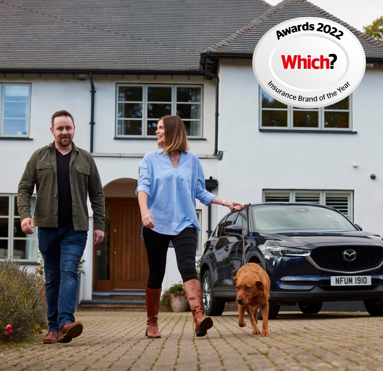 Two customers with dog outside surburban home