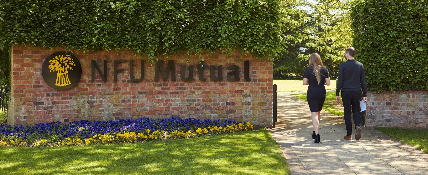 staff-walking-in-front-nfu-mutual-sign