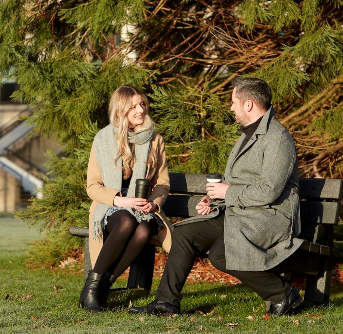 Colleagues sat on bench outside office