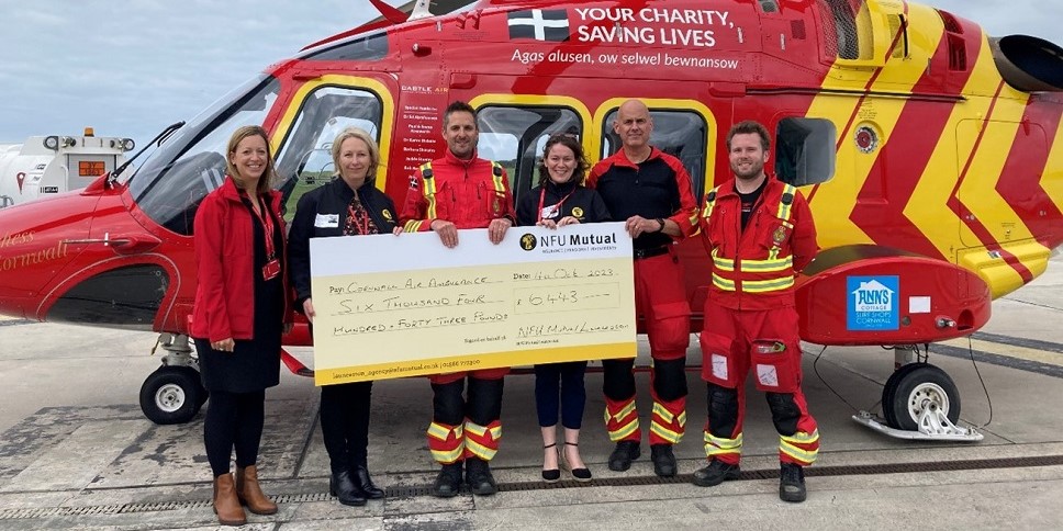 Tiverton Agency presenting cheque to Cornwall air ambulance