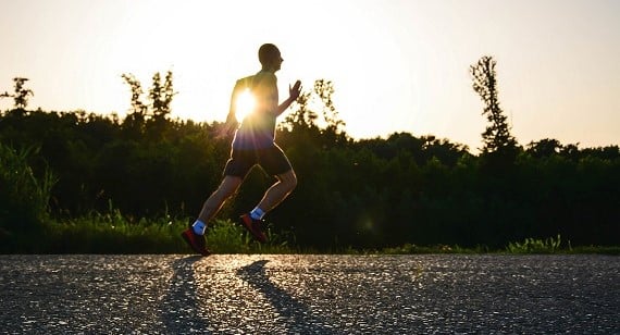 runner on a rural road at dusk