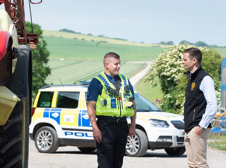 Policeman and NFU Mutual Agent talking next to tractor