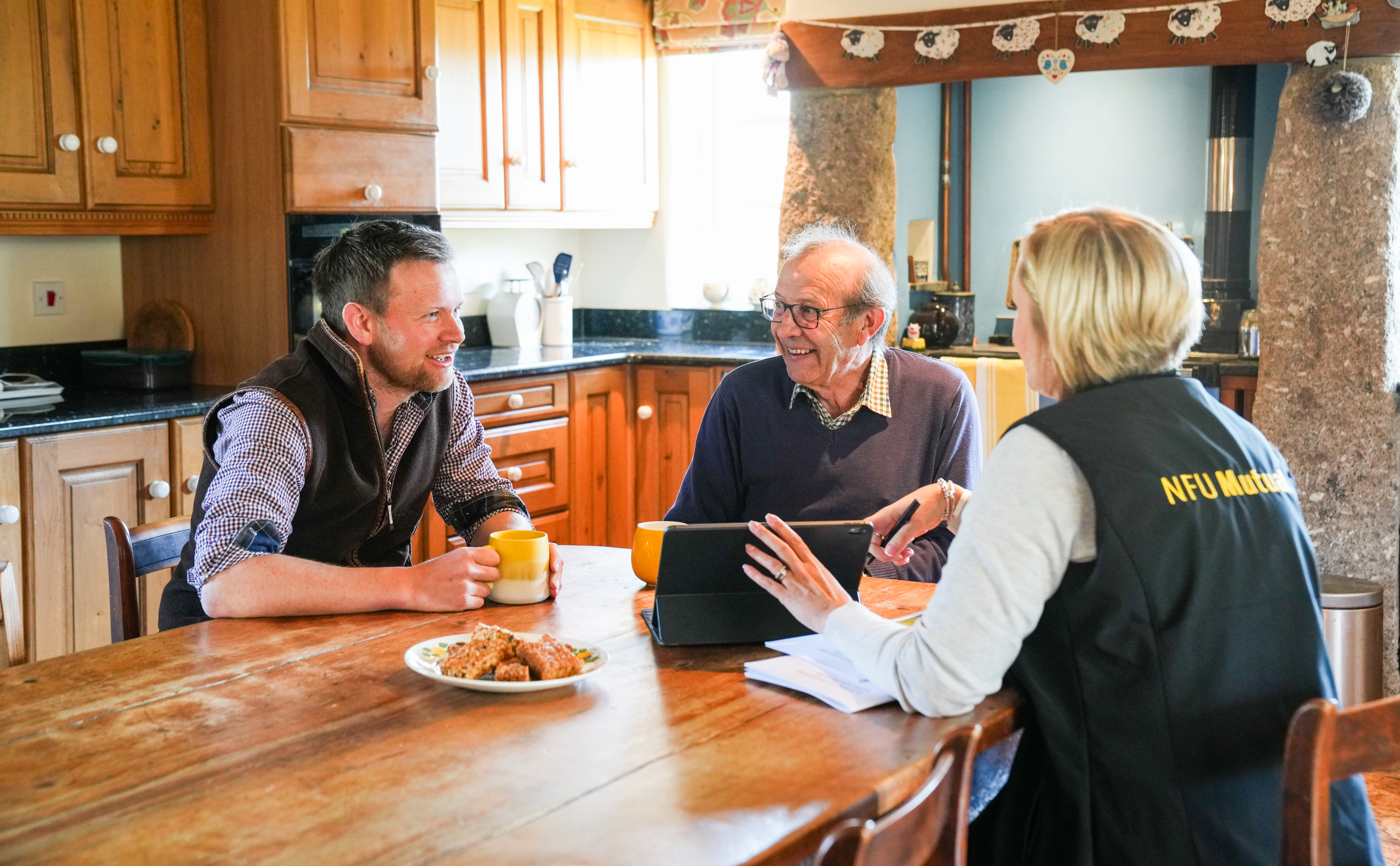 Group of people sat around a table with an NFUM rep