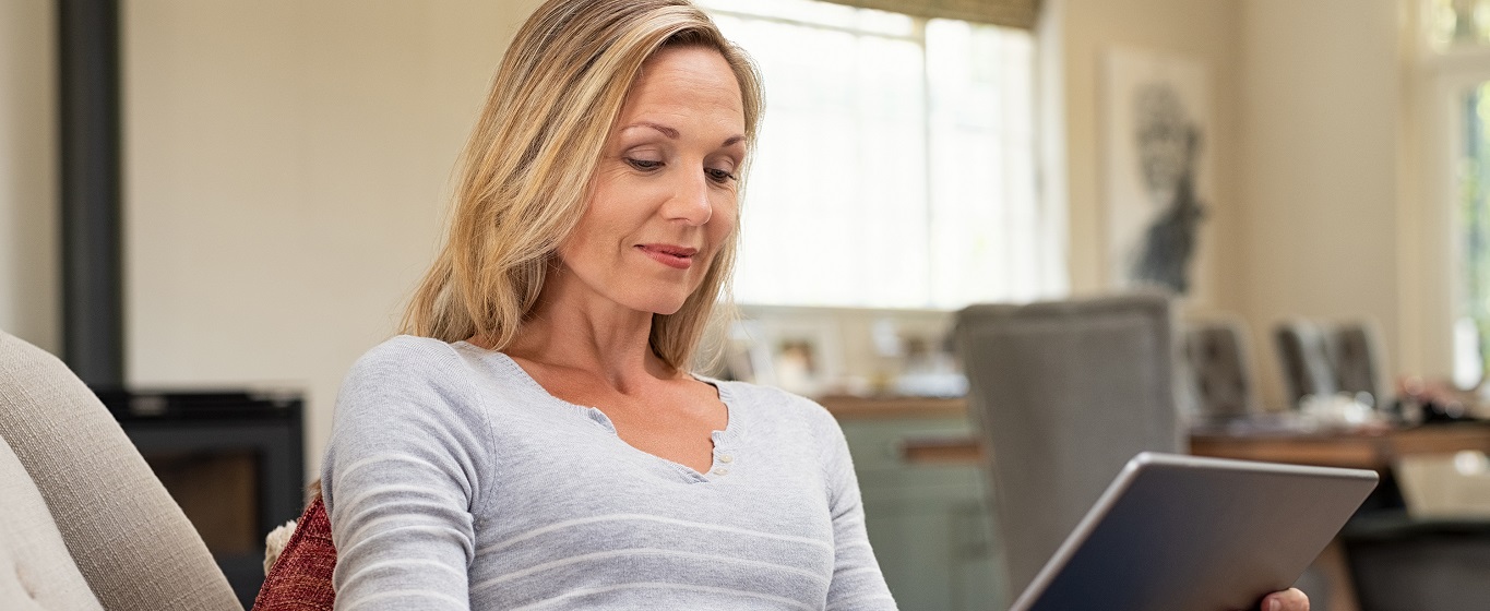 Lady on sofa viewing tablet