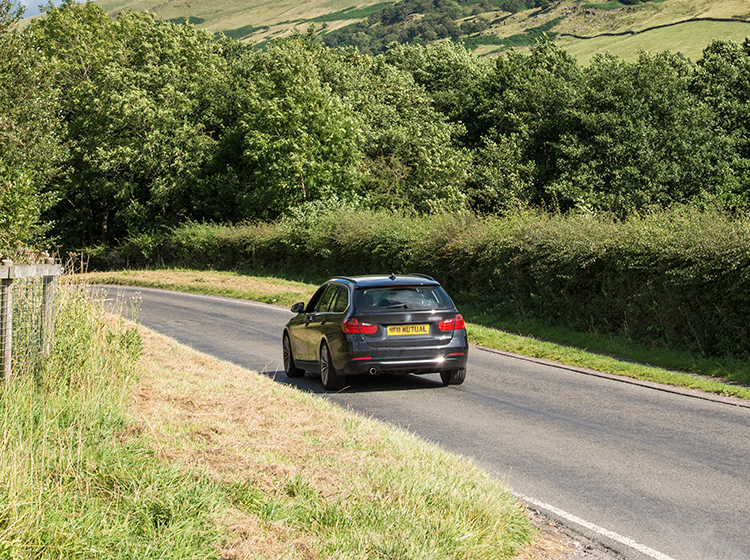 Black BMW on a country road