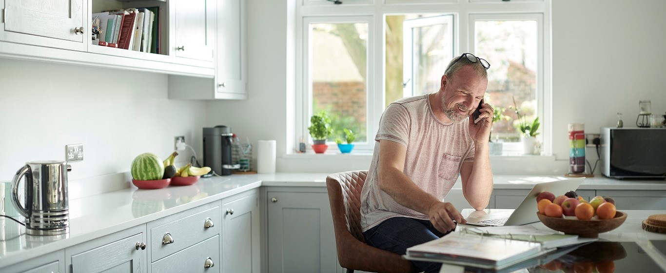 man on the phone in his kitchen