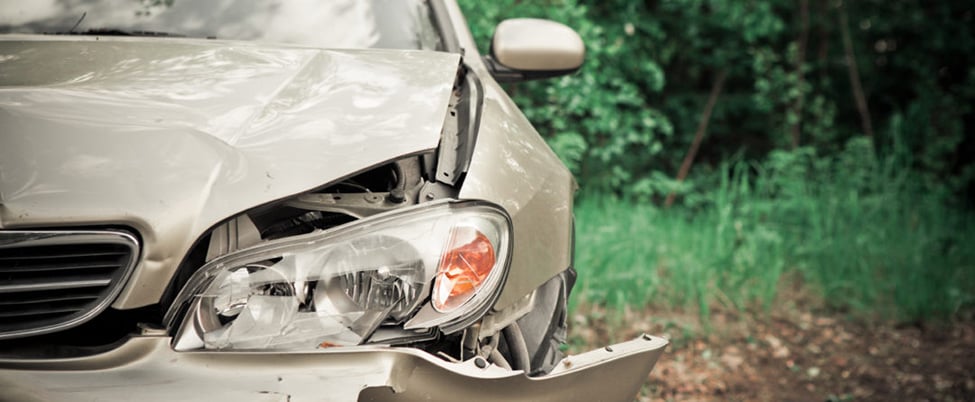 Silver car with right side headlight smashed