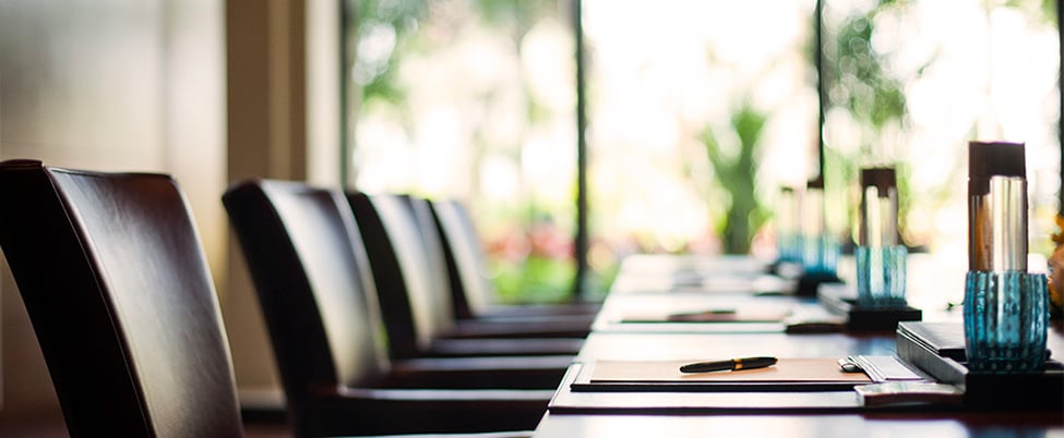 A coroporate boardroom laid out for a meeting