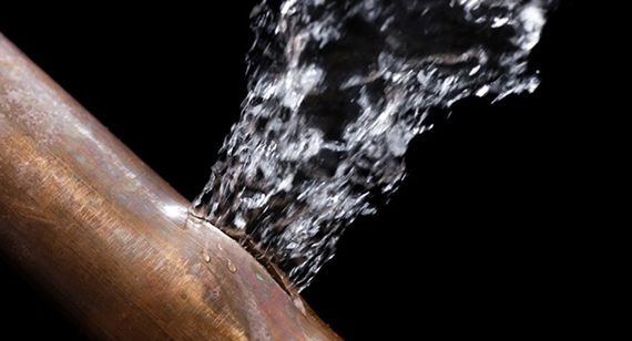 Bronze bursted pipe with water spirting out